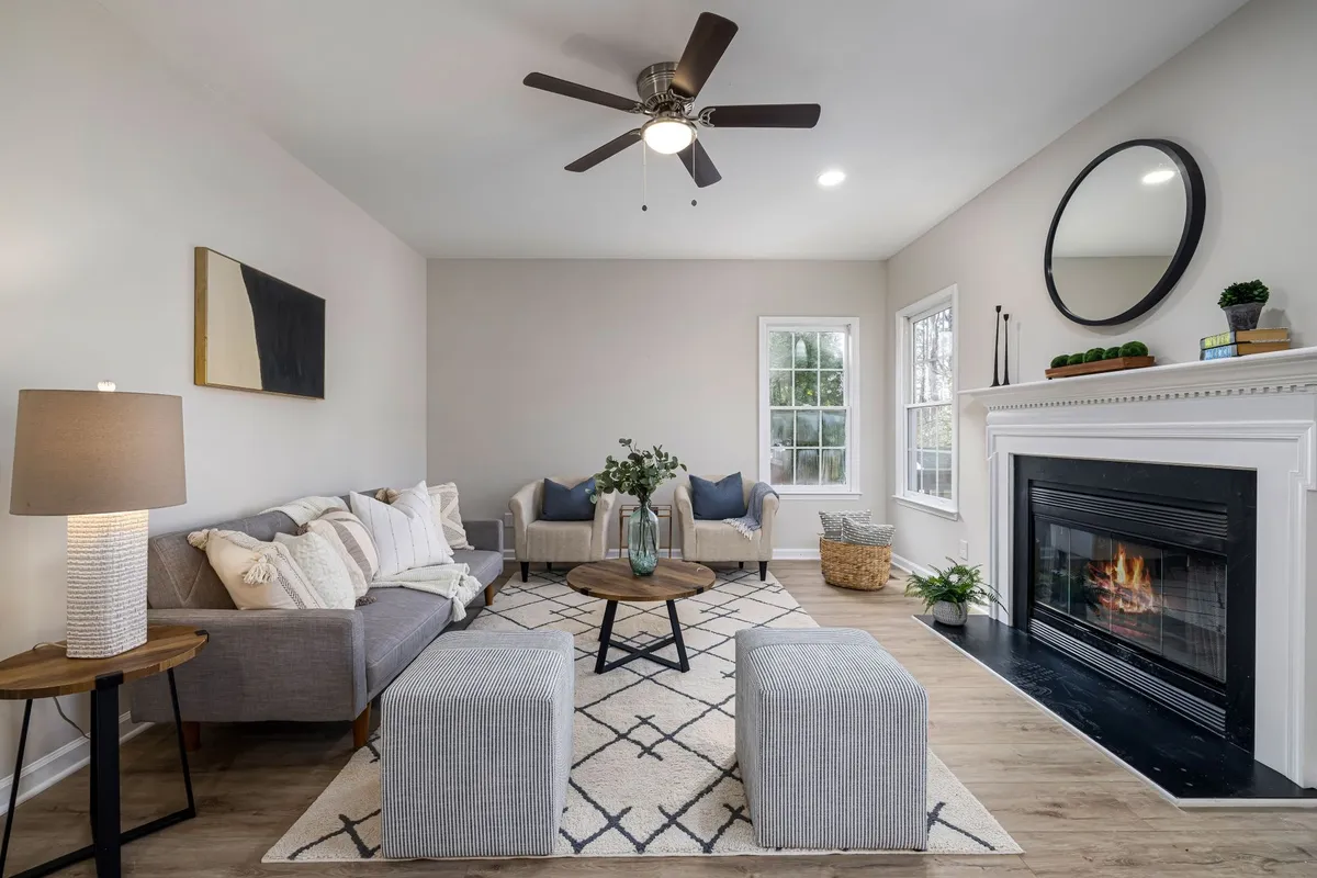 A cozy living room with modern furniture and a fireplace, ideal for creating a welcoming atmosphere while selling.