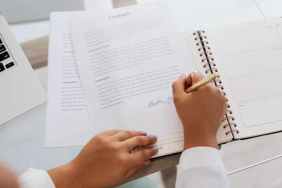 A close-up of listing agreements highlighting the details of working with real estate agents.